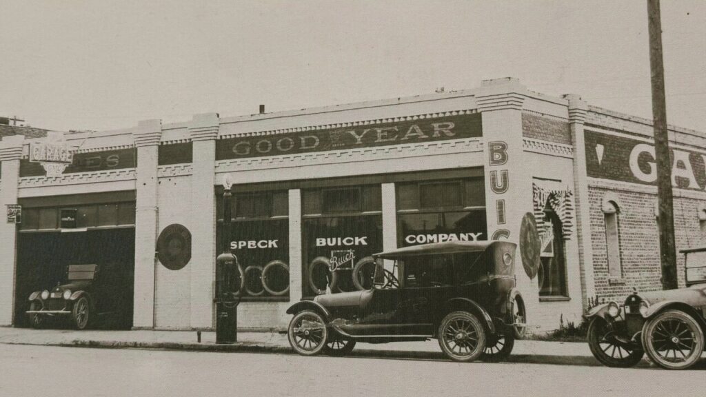 Historic Speck Buick Company dealership with vintage cars parked outside