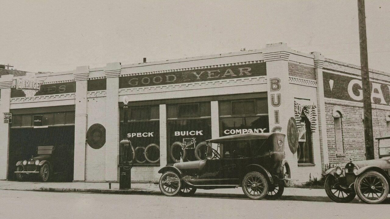 Historic Speck Buick Company dealership with vintage cars parked outside